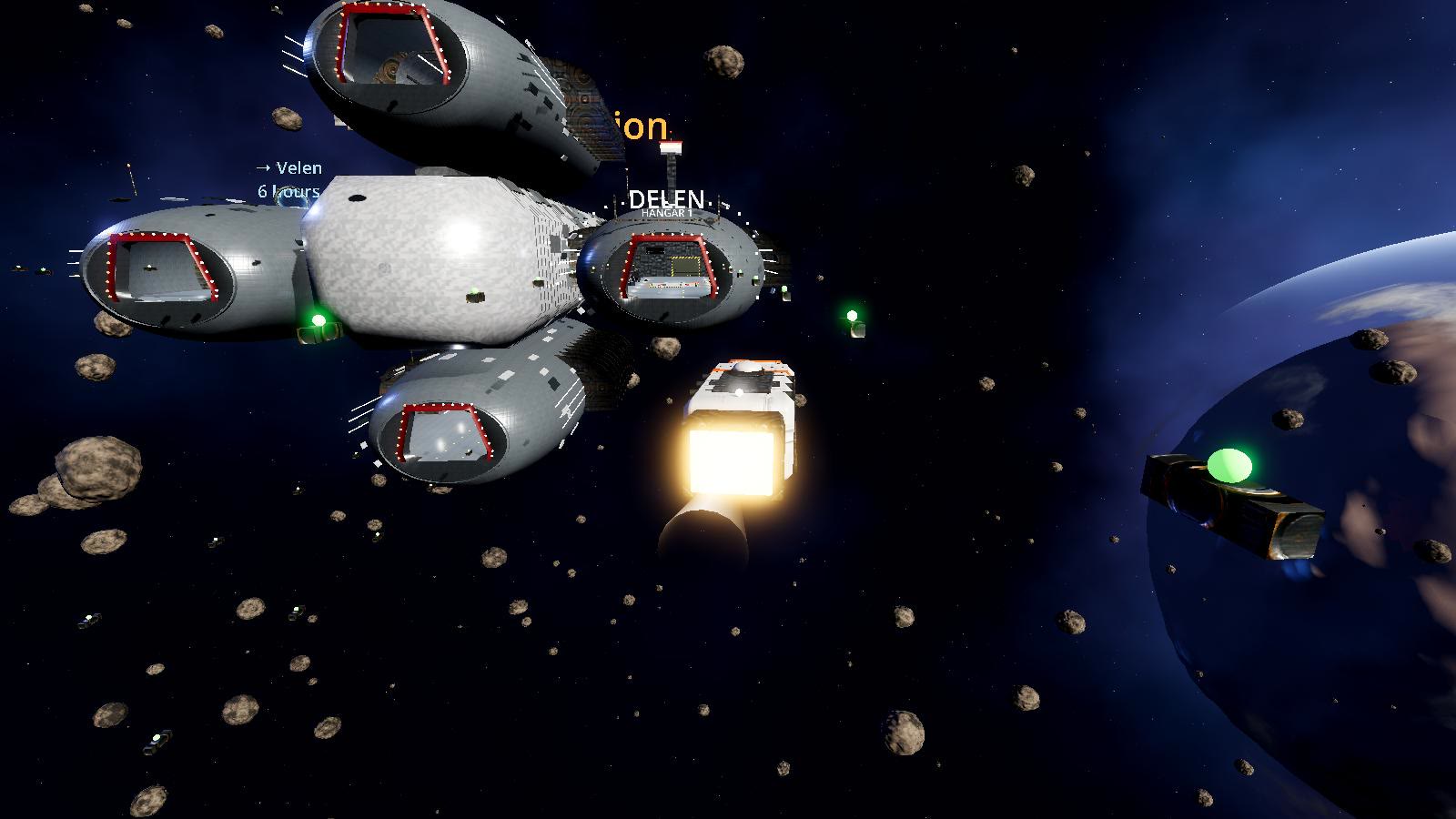 A station with four hangar pods. Each pod's mouth is lit; the green posts mark the approach lane.